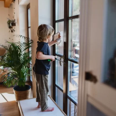 side-view-of-little-boy-cleaning-windows-indoors-a-2022-01-19-00-09-53-utc
