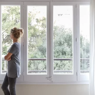 woman-at-home-looking-out-of-window-2022-03-04-01-54-40-utc